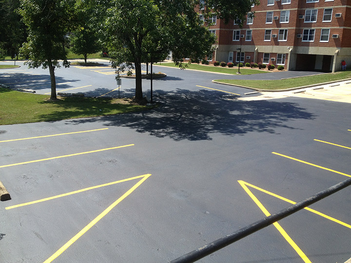 paint striping on a parking lot outside of a mult-story building