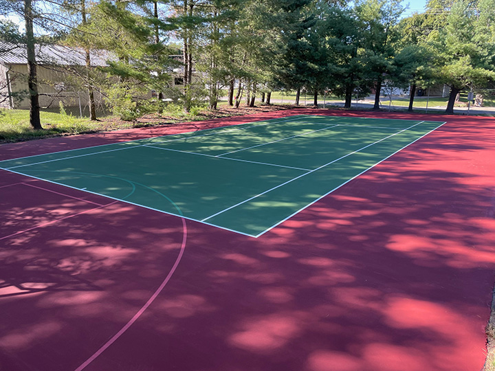 a resurfaced tennis court with the net not installed