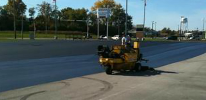 asphalt being applied to a parking lot