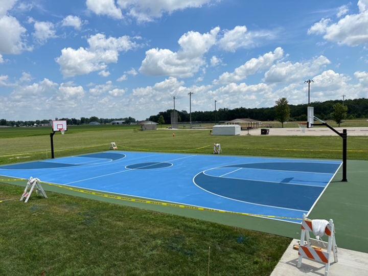 resurfaced outdoor basketball court with two different blue colors
