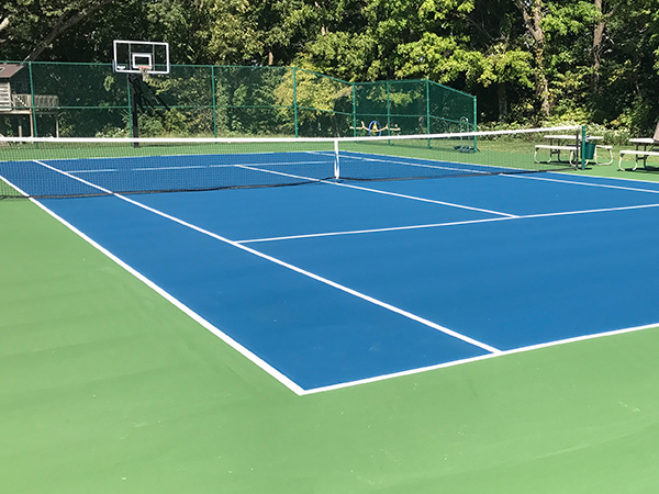 view of a blue tennis court after resurfacing