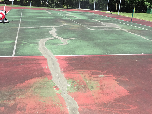view of a tennis court before resurfacing