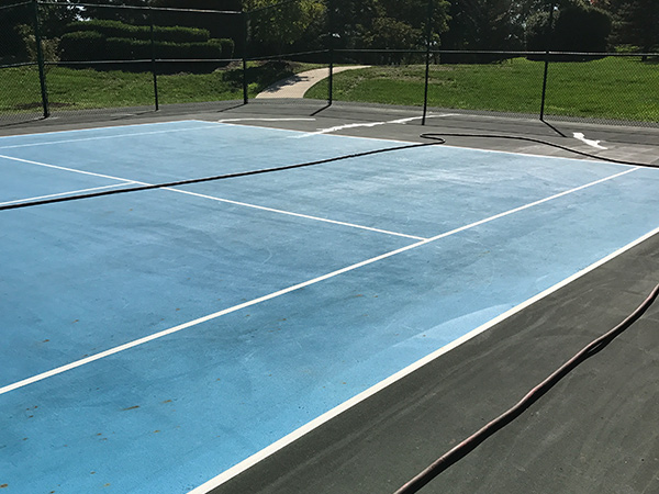 view of a blue tennis court before resurfacing